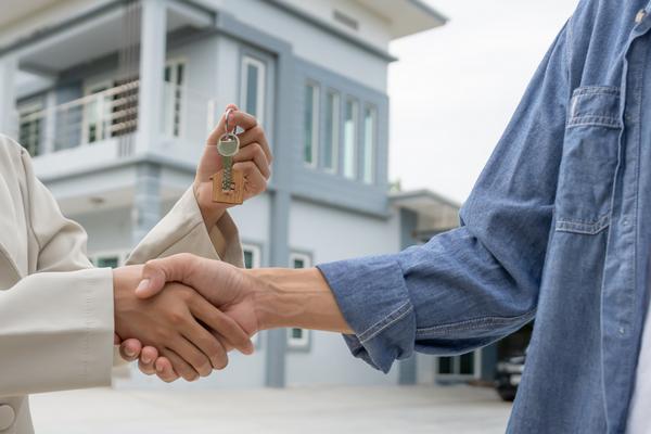 Real estate agent handing keys to homeowner